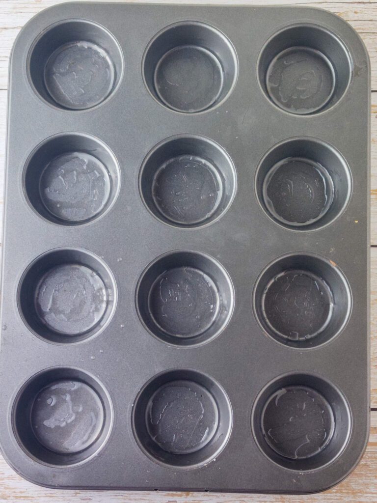 greasing the muffin tin tray