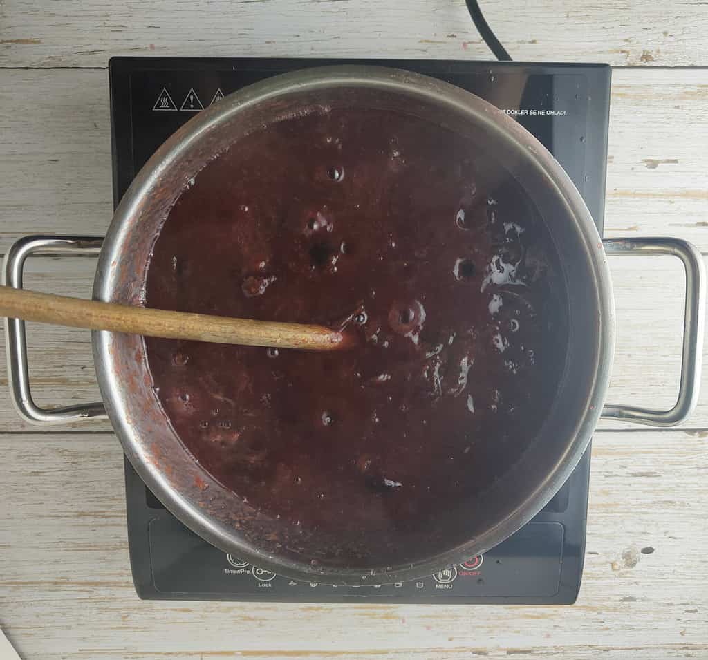 simmering plum jam with cinnamon 
