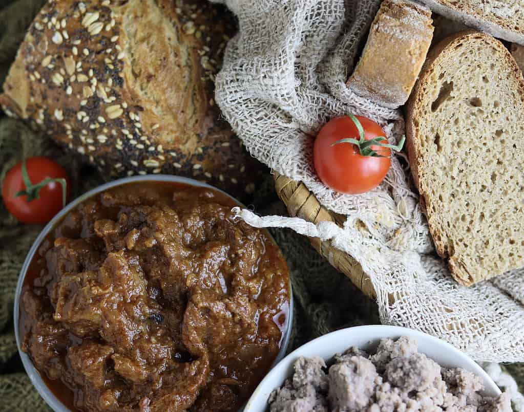 authentic gulasz wolowy (polish goulash) served with duplings and fresh homemade bread 