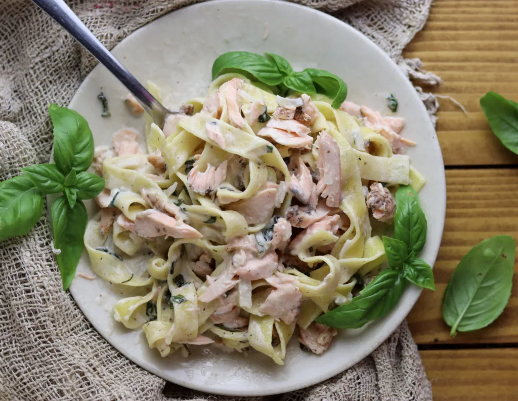 photo of a delicious meal with pasta alla salmone, with cream sauce and basil