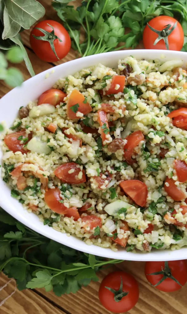 taboule oriental in a bowl with tomatoes, parsley and mint