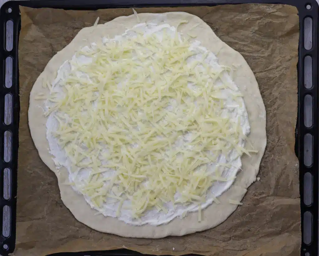 step 9: top the pizza with shreded cheese