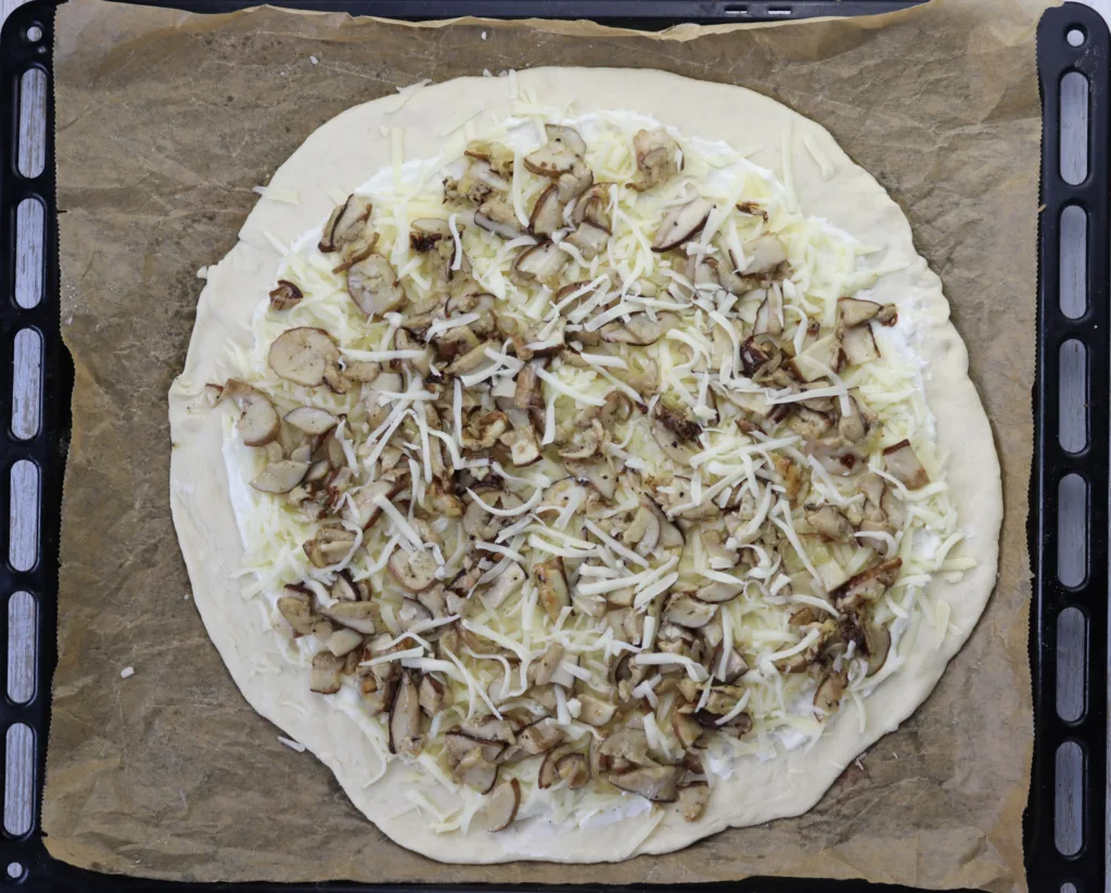 step 10: hot to top the pizza with porcini mushrooms