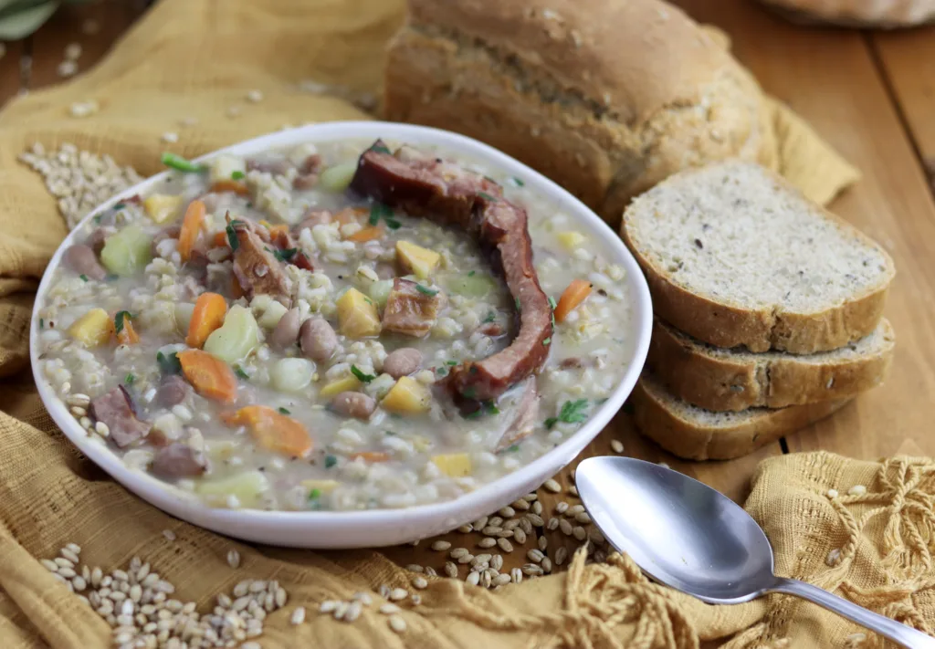 image of a bowl of ricet with pork ribs and homemade bread with a spoon