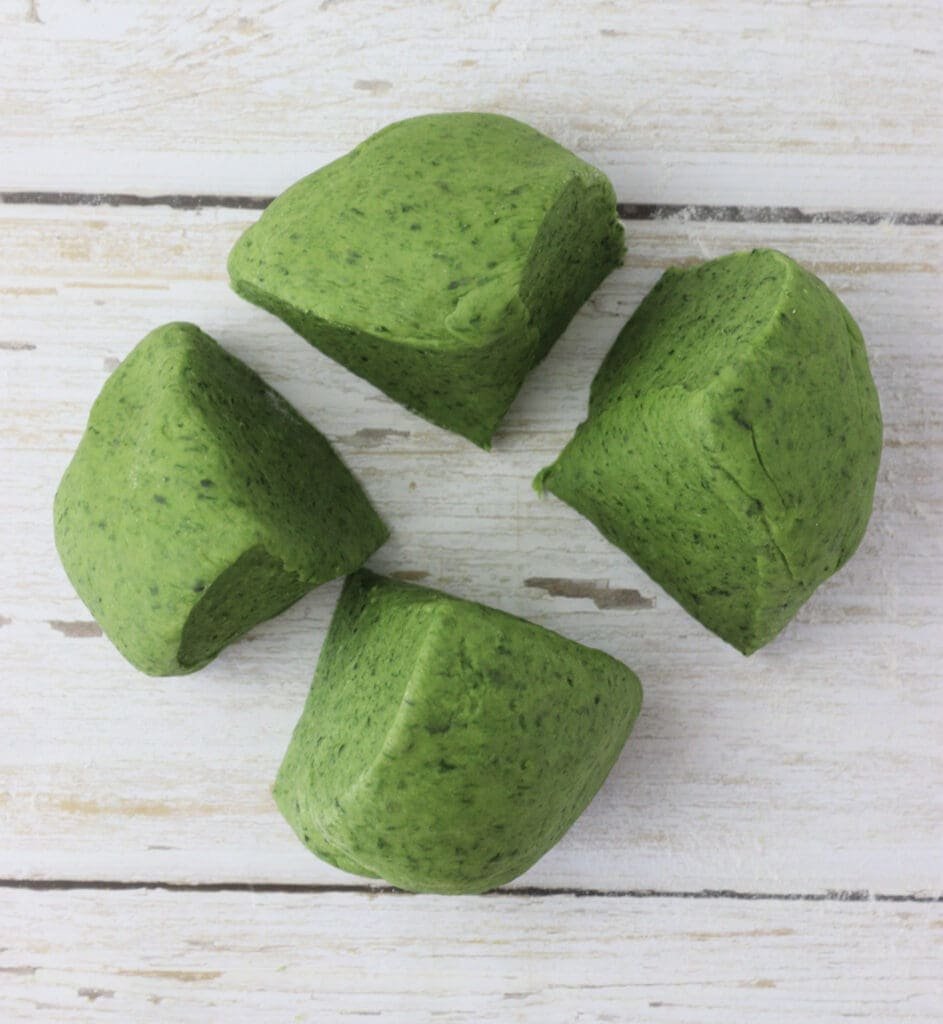 how to split the dough ball into four even pieces before rolling it out