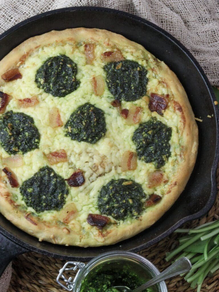 image of freshly baked wild garlic pizza coming out of the oven