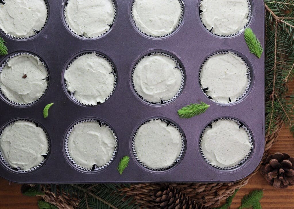 Image of how to fill the muffin liners with creamy spruce tip mixture. 
