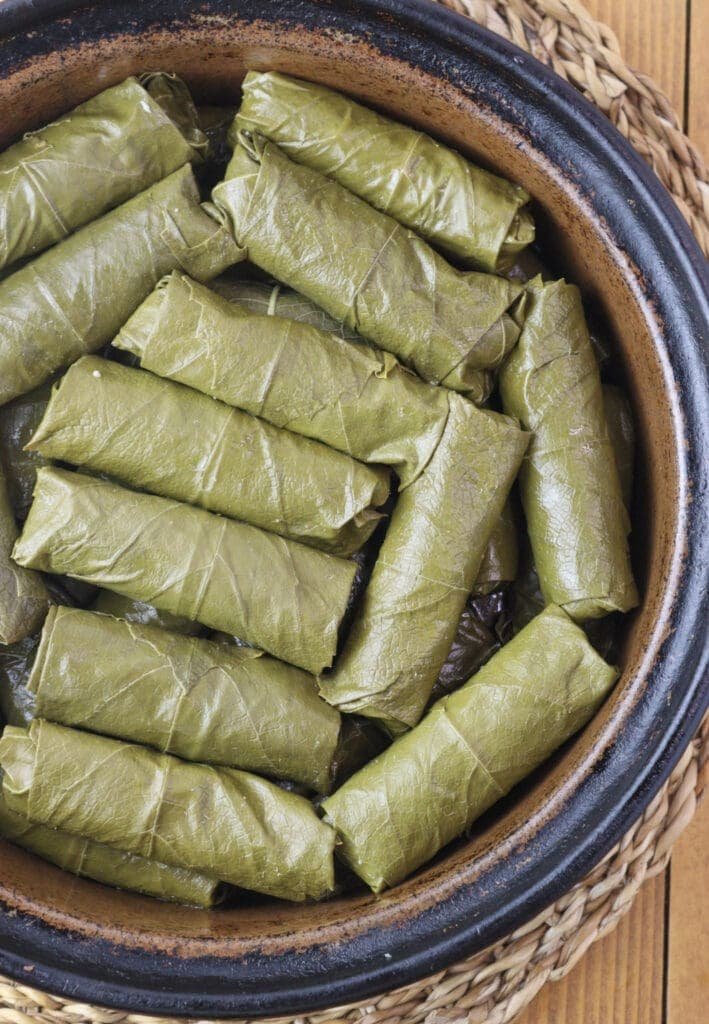 Japrak dolmas in a baking pot waiting for the sauce.