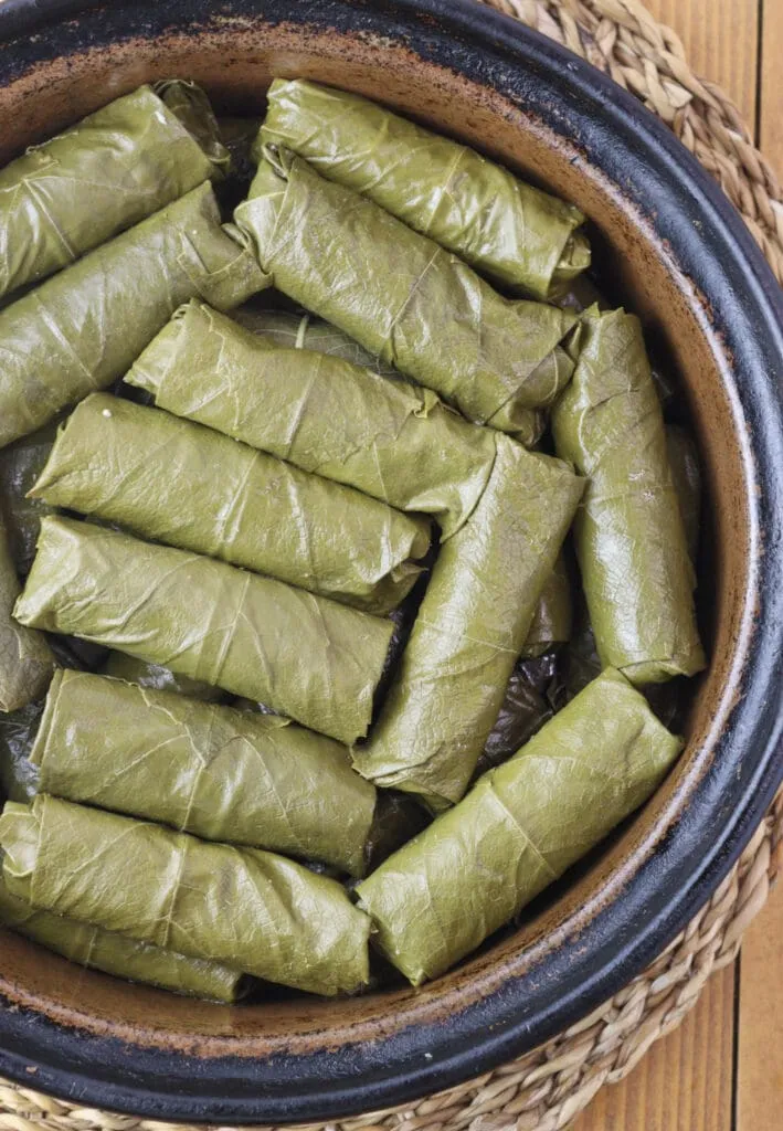 Japrak dolmas in a baking pot waiting for the sauce.