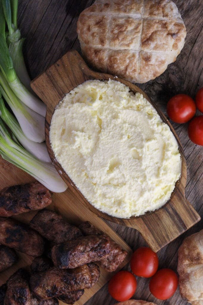 a bowl of delicious homemade kajmak served on the table 