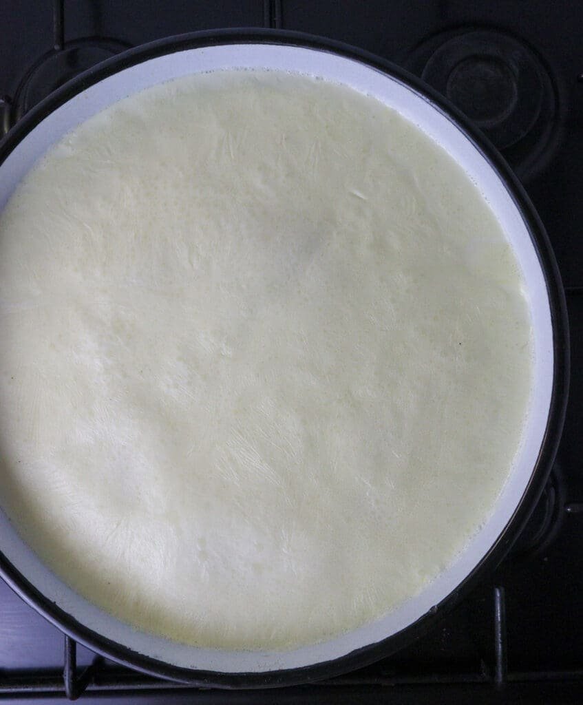 milk in the baking pan is starting to boil