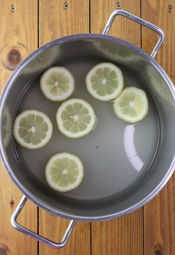 Preparing lemons, water and sugar for sugar syrup
