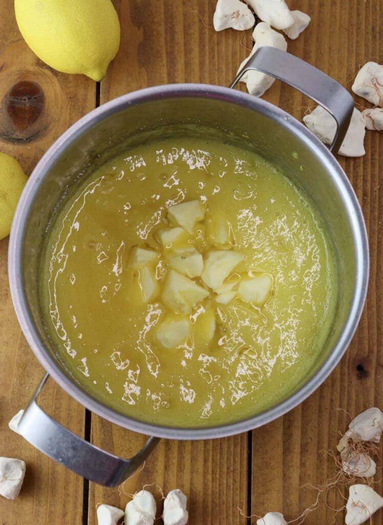 adding butter to the lemon curd mixture 
