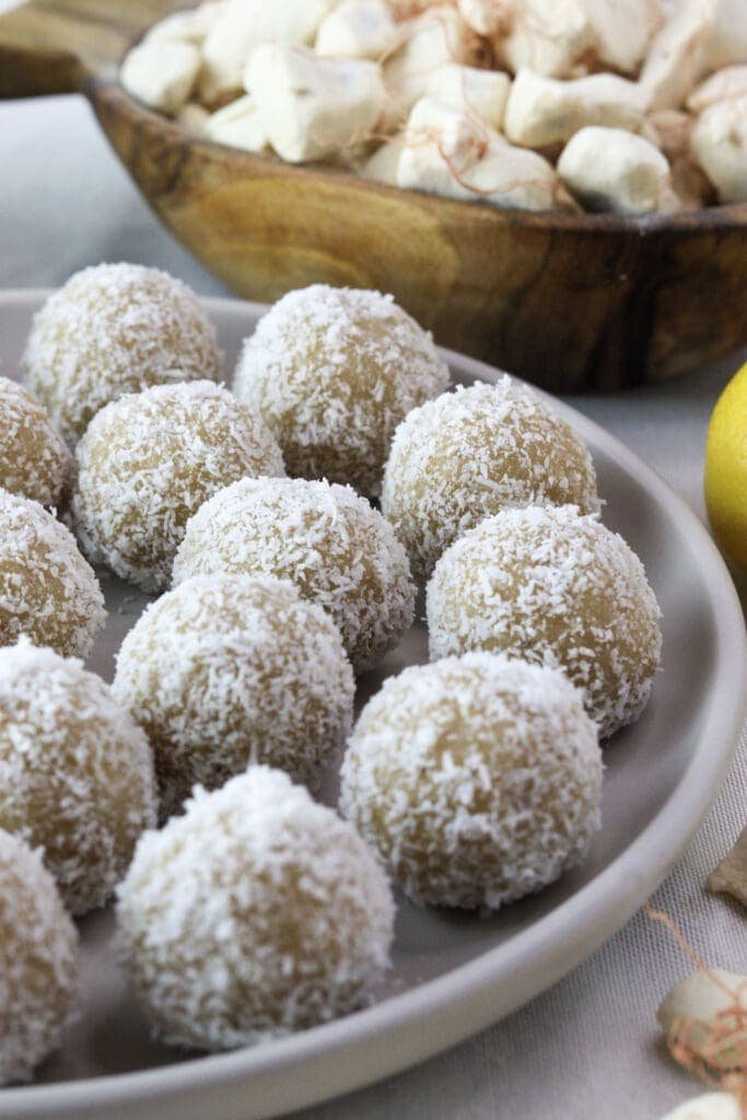 A plate of coconut baobab balls on the table, a healthy snack made with baobab powder.