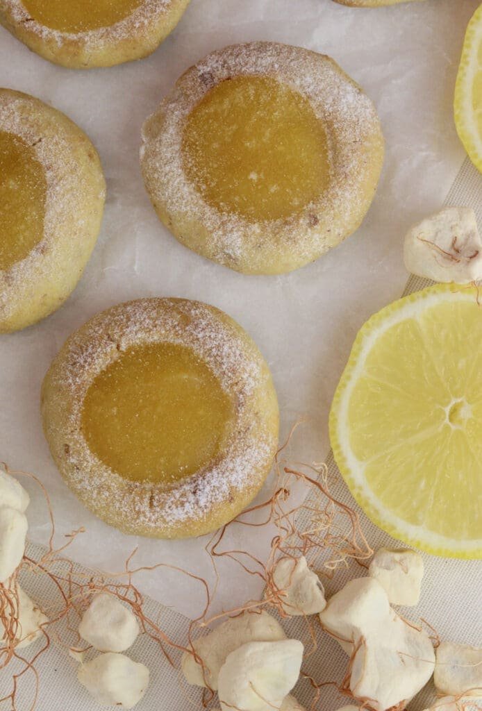 Lemon baobab cookies with baobab fruit pulp and slices of lemon around them, a tangy treat made with baobab powder.