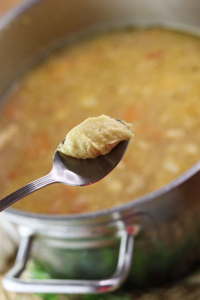 Adding dumplings to the soup.