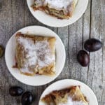 Three plates of delicious plum strudel with cinnamon.