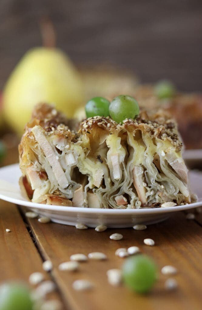 A slice of baked chicken of the woods pie with two grapes on top