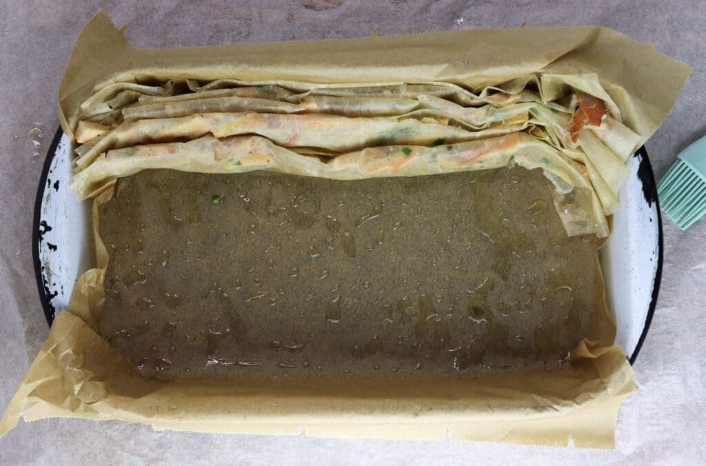 Image showing how to stack phyllo sheets with chicken of the woods filling into a baking pan