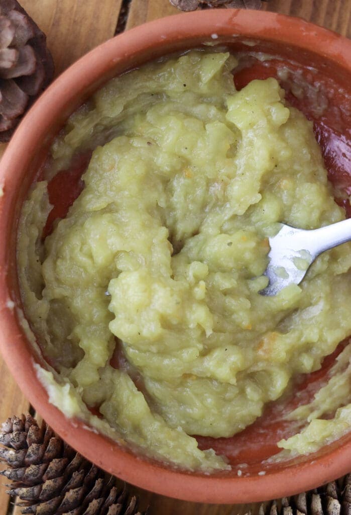 Image showing how to mash the potato to thicken the soup.