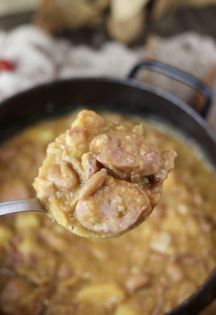 A full ladle of delicious, homemade jota soup with sauerkraut, potates, beans and carniolan sausage.