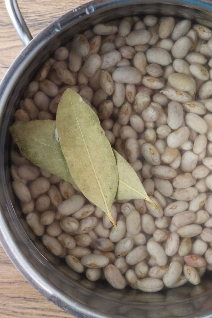 How to cook the beans before adding them to the soup together with two bay leaves