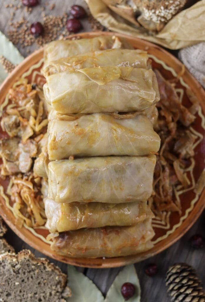 A stack of baked stuffed cabbage rolls with buckwheat on an old, traditional clay plate.