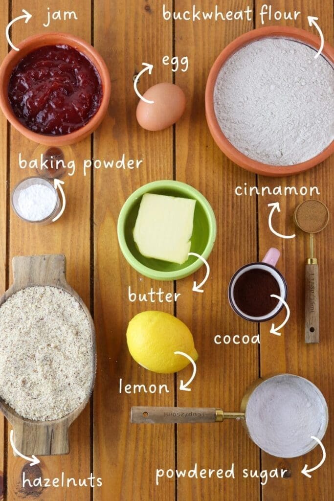 Ingreedients mis en place - buckwheat flour, hazelnuts, butter, baking powder, egg, cinnamon, powdered sugar, jam, baking powder, cocoa and lemon zest