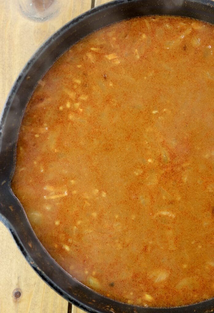Adding water to the sauce and cooking it for a few minutes before adding the sauce to stuffed cabbage rolls.