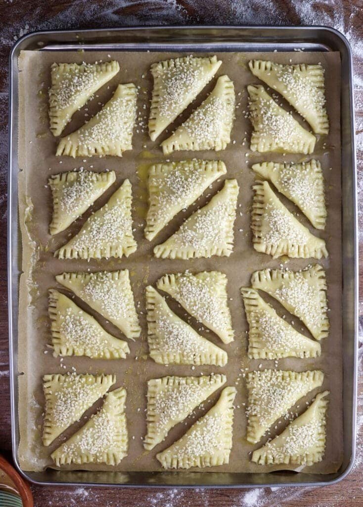 Crackling cookies before baking covered with egg wash and sprinkled with sesame seeds.