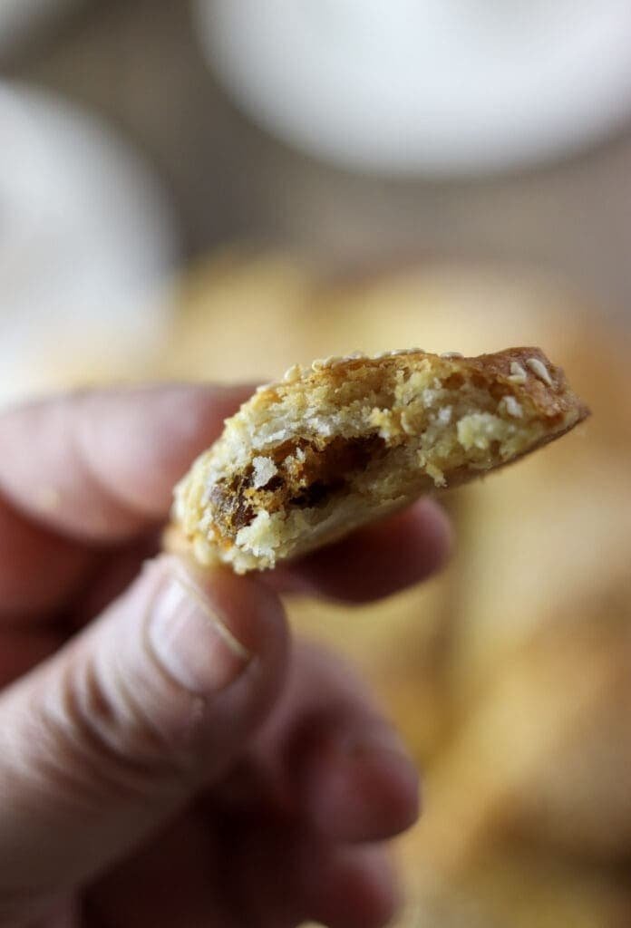 A half of a cookie showing a delicious, crispy pork cracling filling.
