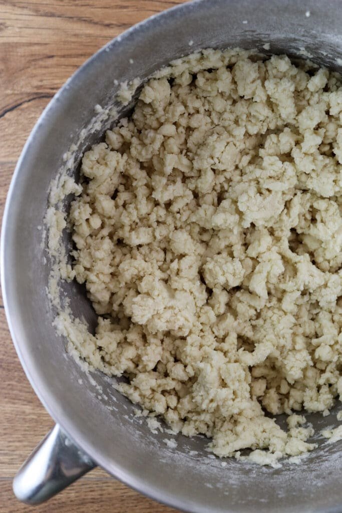 Mixed dough that looks like like crumbs before kneading it into a dough ball