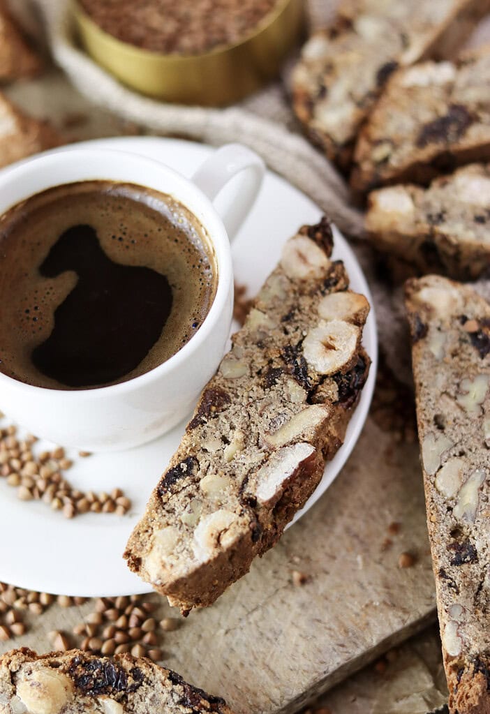 Buckwheat biscotti served alongside a warm cup of coffee.