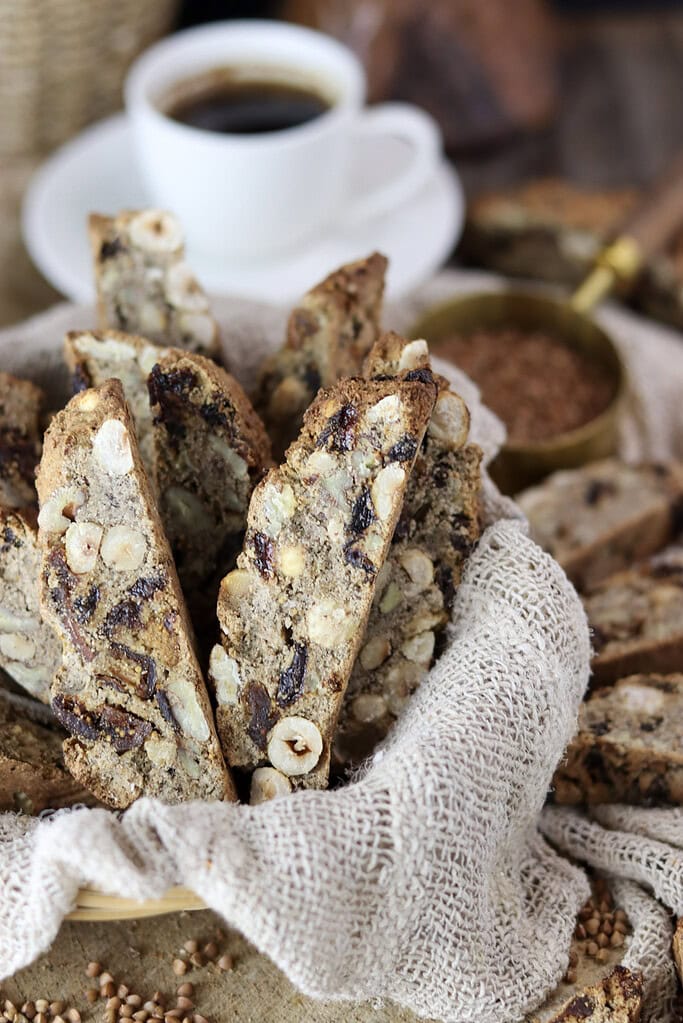 Homemade buckwheat biscotti stacked in a basket, showing their golden-brown texture.