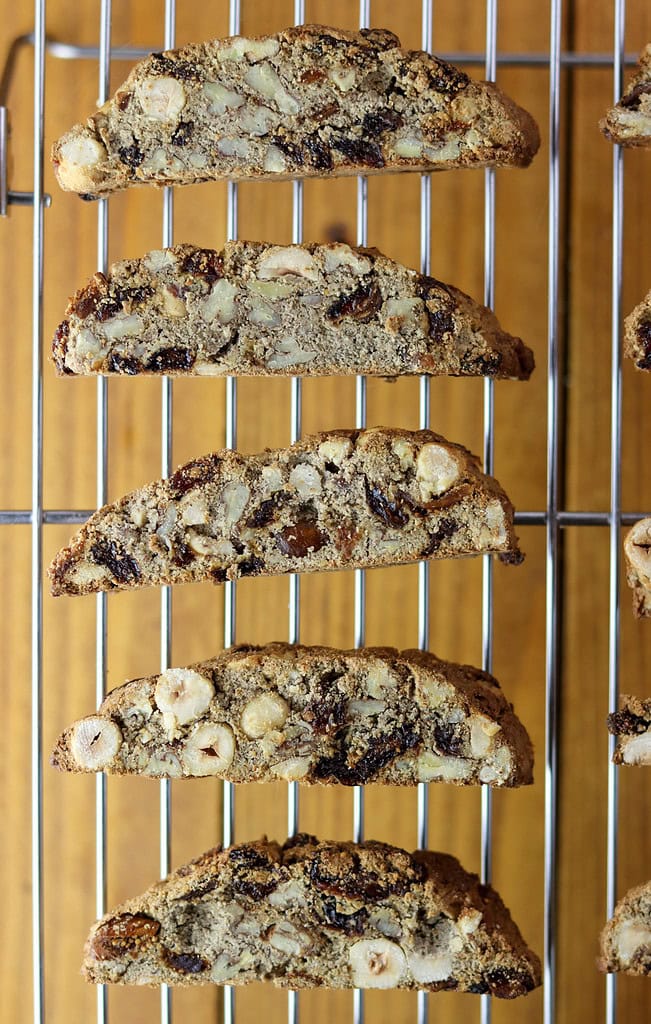 Biscotti cookies being placed on a cooling rack to cool before enjoying.