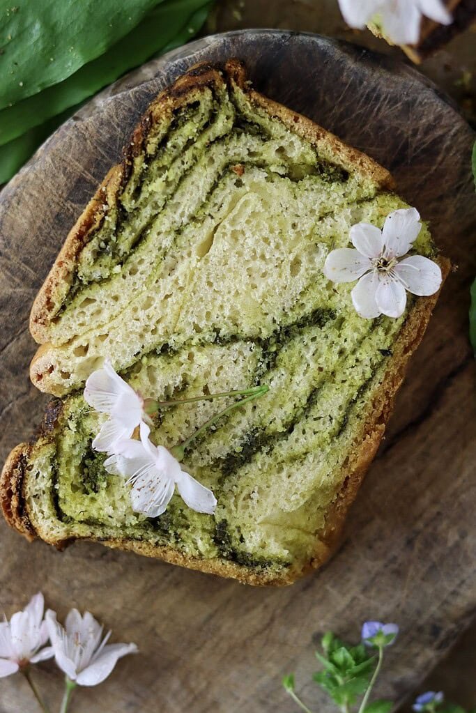 A slice of wild garlic bread with white cherry flowers.