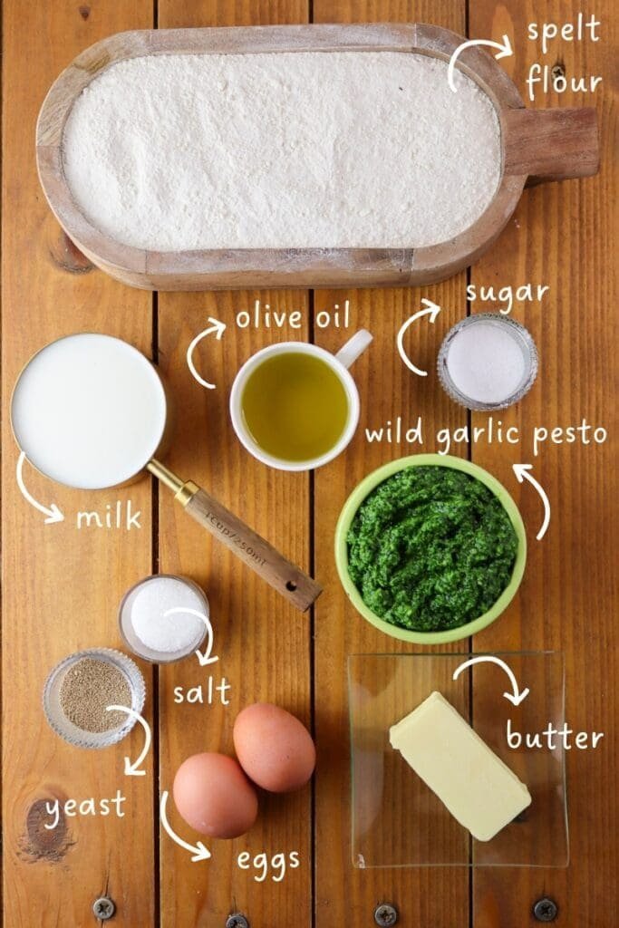 Ingredients needed for wild garlic bread: spelt flour, wild garlic pesto, milk, two eggs, olive oil, salt, sugar, dried yeast and butter.
