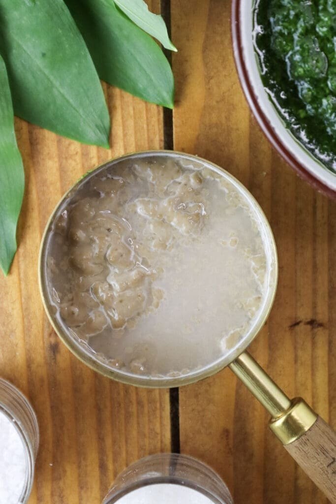 Soaking dried yeast in warm water with sugar to activate it before kneading the dough