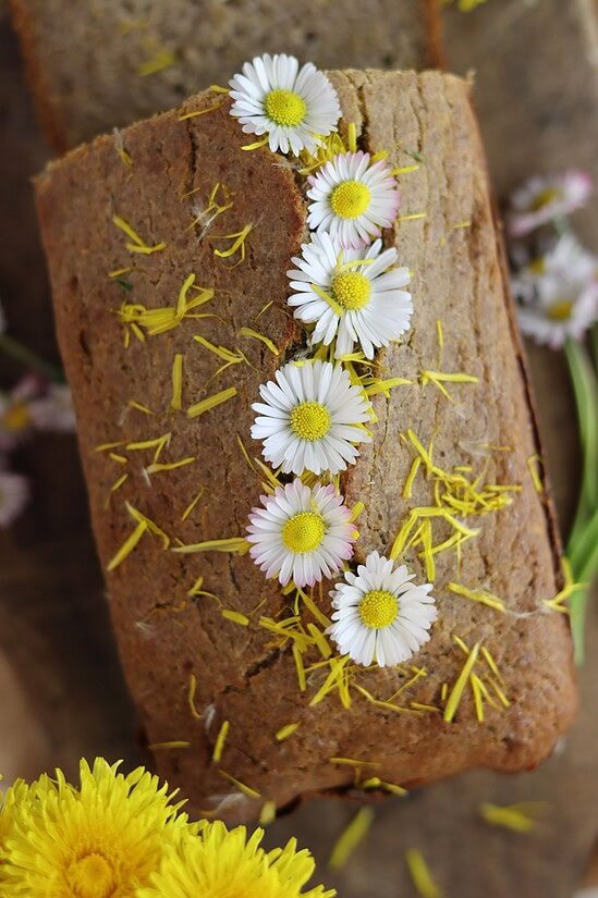 Buckwheat dandelion bread loaf with honey and flowers.