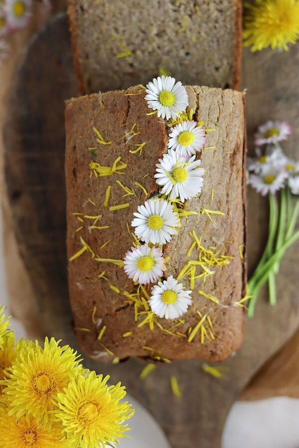 A loaf od dandelion bread with honey, made with buckwheat flour, decorated with flowers.