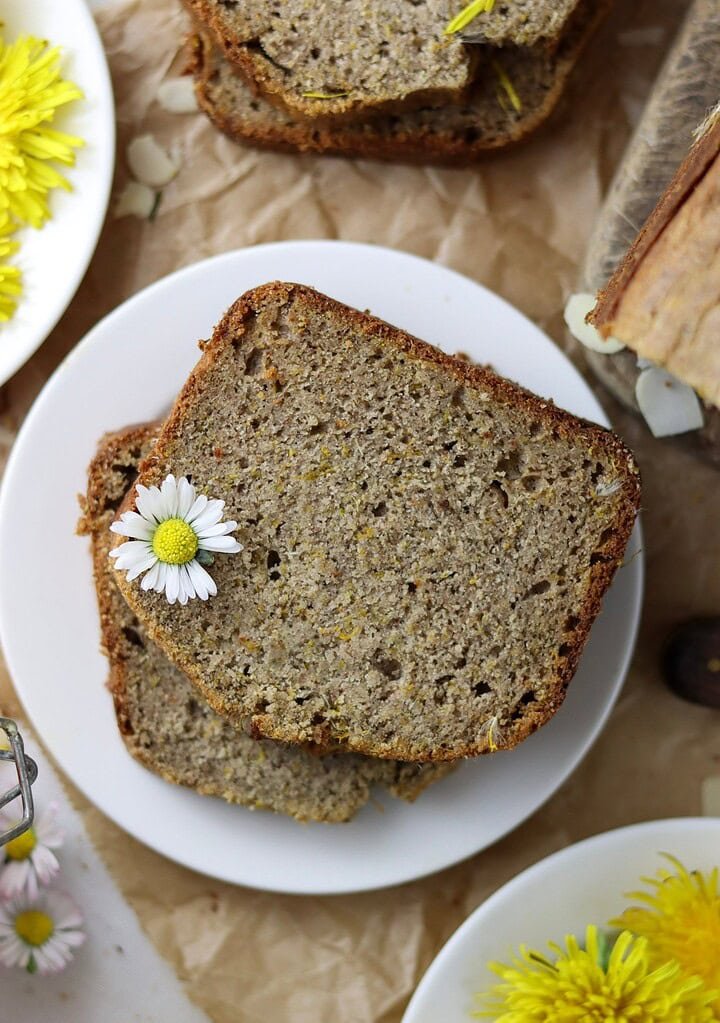 Two pieces of dandelion buckwheat bread on a small plate.